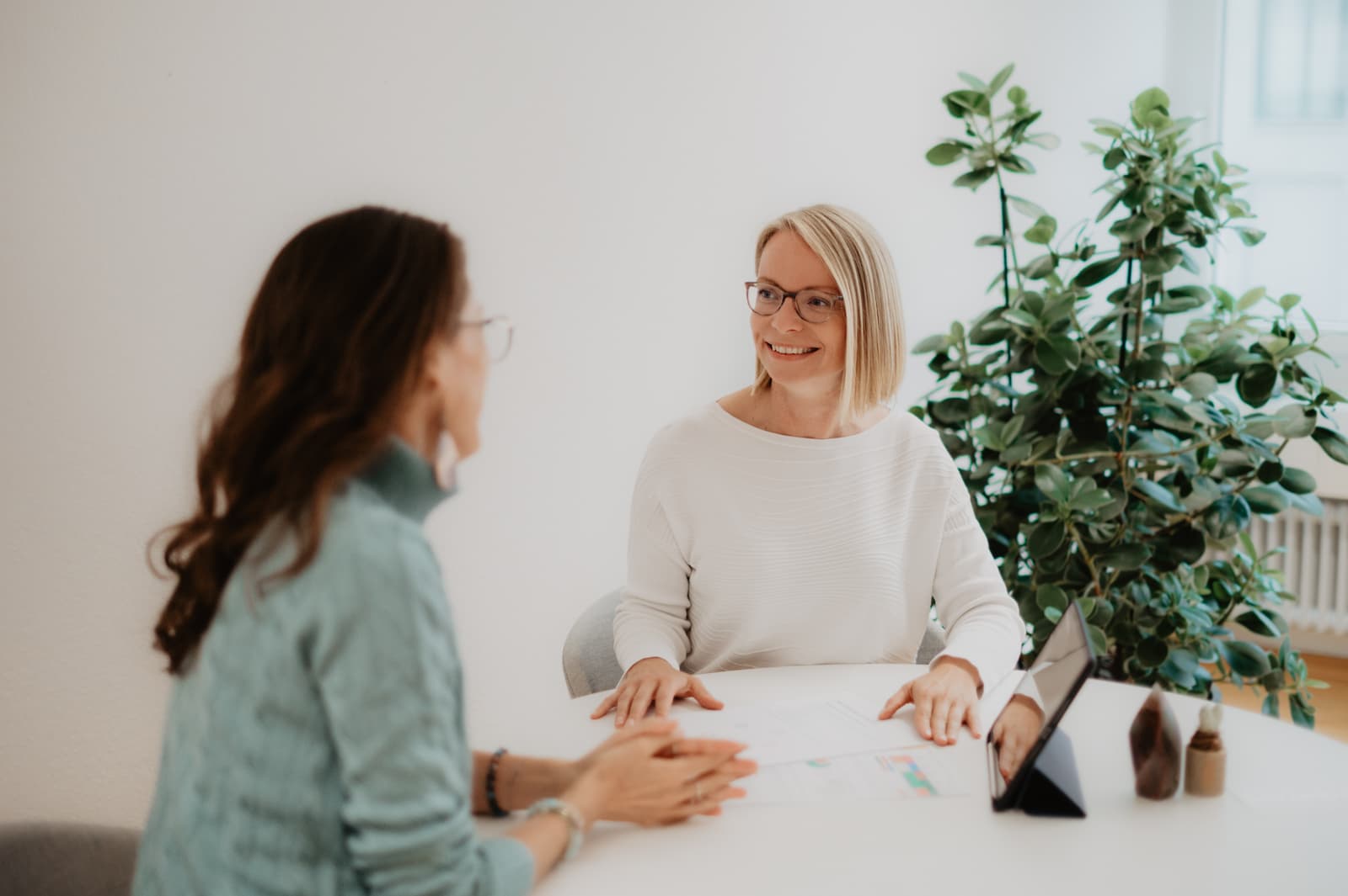 Maria Kosmala in einer persönlichen Beratungssituation während der Bazi Suanming Ausbildung in ihrer Akademie mit Teilnehmerin am Tisch