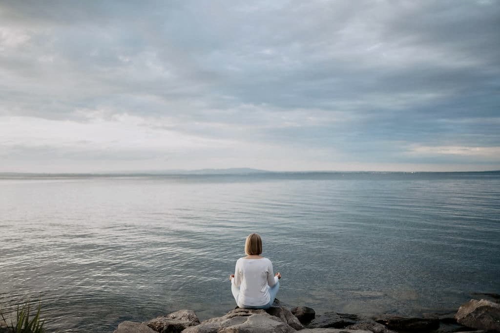 Ruhige Frau am See in Meditation – Innenschau und Elemente-Balance für den Daymaster im Bazi Suanming.